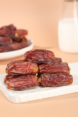 Golden Dried Dates Fruit Stack on Wooden Board with Milk Glass - Healthy Natural Sweet Snack Food Photography