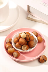 Fresh Hazelnuts in Bowl - Shelled and Peeled Nuts Display on Pink Plate