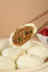 Handmade Pork Buns with Fresh Scallion and Meat Filling in Traditional Bamboo Steamer