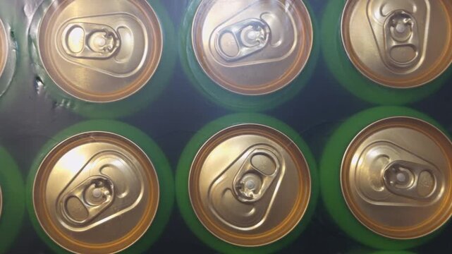 Top view of a pack of aluminum drink cans with golden lids.
