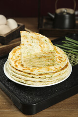 Handmade Scallion Pancakes Stack - Golden Pan-Fried Asian Flatbread with Green Onions on White Plate