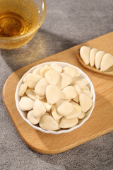 Peeled Sliced Blanched Almonds in Bowl on Wooden Board with Honey - Healthy Cooking Ingredient