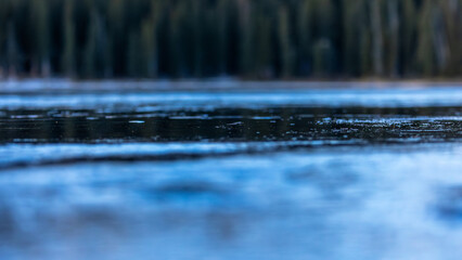 Gentle ripples glide across the lake&rsquo;s surface in a shimmering close-up view.