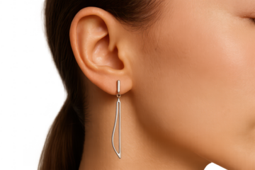 Elegant modern silver earring on a woman's ear, isolated on transparent background