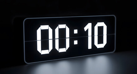 Digital LED alarm clock displaying 00:10 in bright white numbers against a dark background