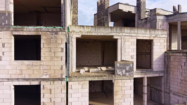 Crumbling concrete frames stand tall, revealing empty spaces where life once thrived. Nature reclaims this forsaken site, creating an eerie yet captivating atmosphere.
