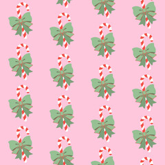 Bożonarodzeniowe cukrowe laski z piękną zieloną kokardą na różowym tle. Świąteczny bezszwowy wzór wektorowy.