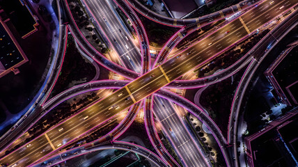 Illuminated Highway Interchange at Night, Aerial View with Vibrant Traffic Lights