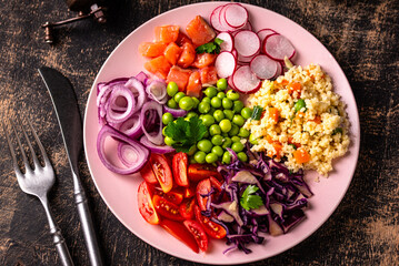 Balanced healthy bowl with vegetables and salmon