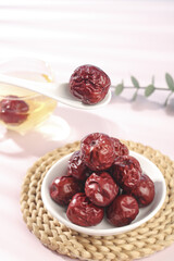 Dried Red Jujube Dates from Xinjiang China in White Bowl - Traditional Asian Superfood Snack