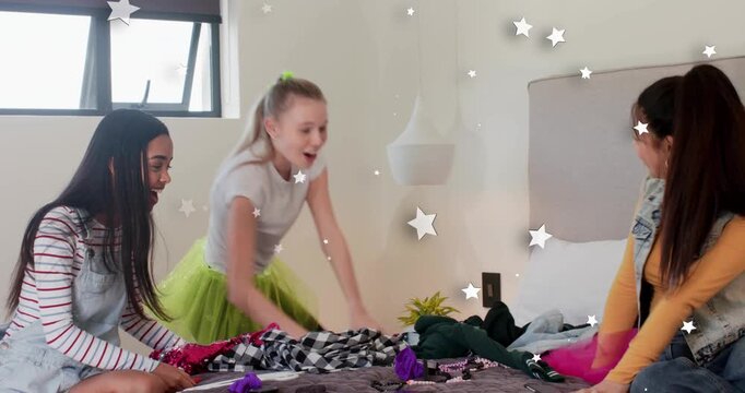 Three girls doing makeup mid girl tossing sweater viewing phone reacting with animated stars beauty