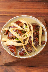 Stewed Duck with Bamboo Shoots - Traditional Asian Cuisine in Ceramic Bowl on Wooden Table