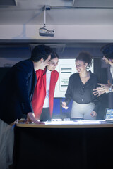 Diverse front-end developer and UX UI design team in a professional discussion over a complex web...