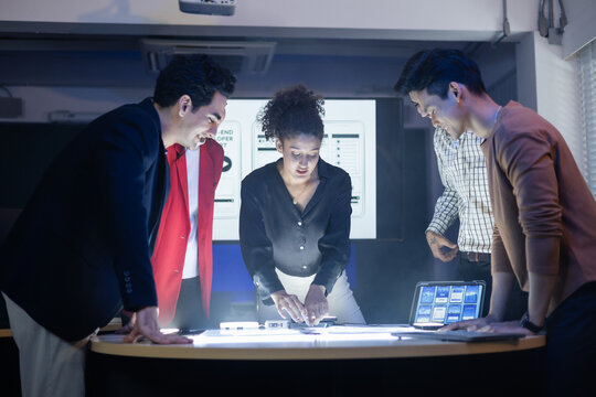 Diverse team of developers and designers having project discussion and strategy meeting. Reviewing digital data, brainstorming UX UI and web design for application development. Startup teamwork - Powered by Adobe