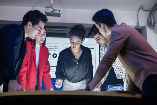 Diverse team of developers and designers having project discussion and strategy meeting. Reviewing digital data, brainstorming UX UI and web design for application development. Startup teamwork - Powered by Adobe