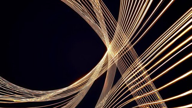 This captivating video features mesmerizing golden lines dancing across a dark background, creating stunning abstract patterns that illustrate the beauty of light and movement in harmony.
