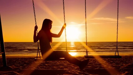Woman on beach swing at sunset enjoying tranquil ocean views