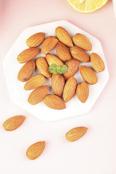 Roasted Almonds with Lemon and Mint on White Plate
