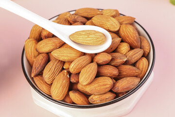 Fresh Almonds in Bowl with Wooden Spoon - Healthy Snack