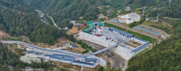 Aerial Construction Site with Industrial Facilities in Mountain Valley © TranPhuoc