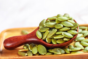 Fresh Green Pumpkin Seeds on Wooden Spoon - Healthy Snack