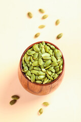 Green Pumpkin Seeds in Wooden Bowl - Healthy Snack Studio Shot