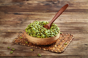 Green Pumpkin Seeds in Wooden Bowl on Rustic Table