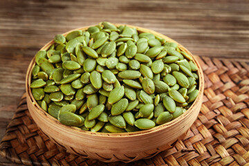 Fresh Green Pumpkin Seeds in Wooden Bowl Studio Shot