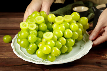 Fresh Green Seedless Grapes on White Plate