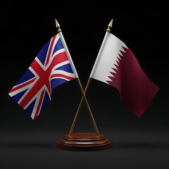 Stunning miniature UK and Qatar flags crossed on a polished wooden base symbolize strong international partnership and diplomacy