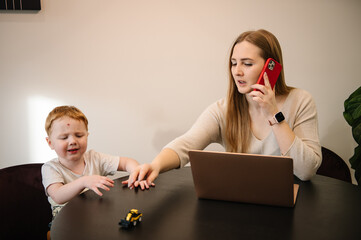 Kid make noise and disturb woman working talking on phone. Mom work on laptop from home with child. Homeschooling and freelance job. Quarantine and closed nursery school. Distance learning through war