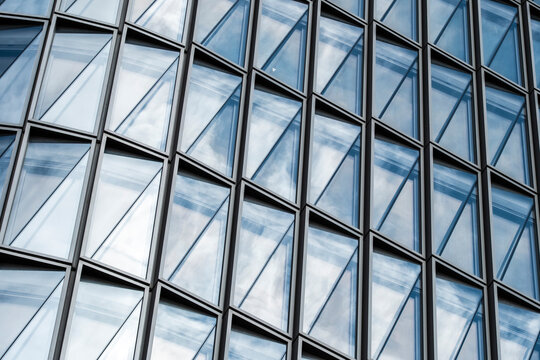Architecture facade glass reflection abstract geometry corporate modern lines pattern reinforcing brand clarity through structured contemporary composition