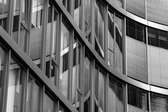 Corporate modern architecture facade glass reflection abstract geometry lines pattern enhancing business presence with refined geometric structure