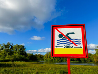 Sign swimming prohibited and icon no swimming near lake shore