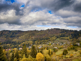 Sunny Autumn Carpathians with Puffy White Clouds