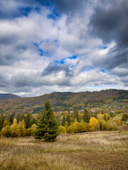 Sunny Autumn Carpathians with Puffy White Clouds