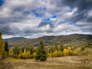 Sunny Autumn Carpathians with Puffy White Clouds