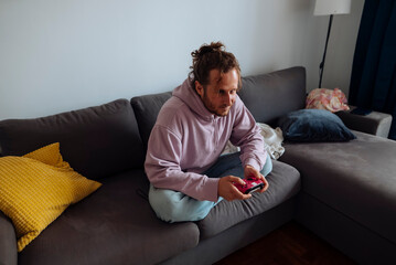 caucasian man gamer and streamer on couch with controller