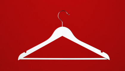White wooden clothes hanger isolated on red background for sales, marketing, fashion, retail, empty coat hanger 