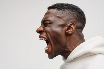 Obraz premium A man with a shaved head and a beard is screaming