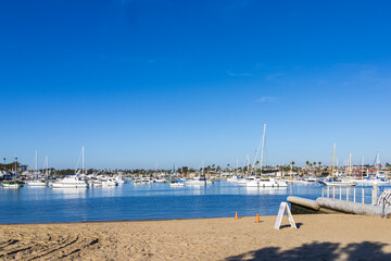 Obraz premium Boats and yachts docked on the Newport Bay at Marina Park in Newport Beach California USA