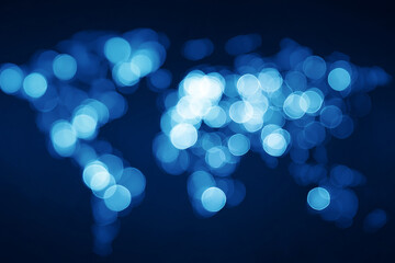 Abstract world map illuminated with soft blue bokeh lights highlighting the connections between continents and representing global communication and data exchange
