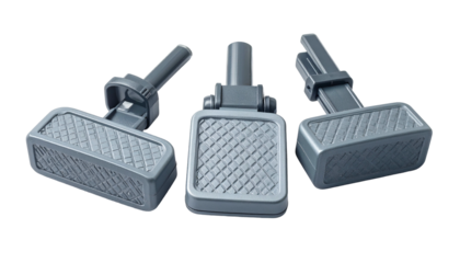 Three identical, gray foot pedals with textured treads, angled against a black background