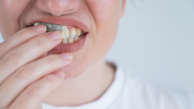 A woman uses chewing tobacco. 