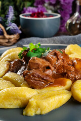 Beef stew in gravy served with potato dumplings.
