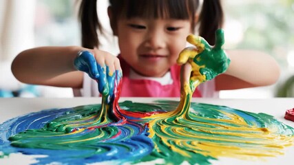 Young child finger painting vibrant colors engaging creative play and artistic development