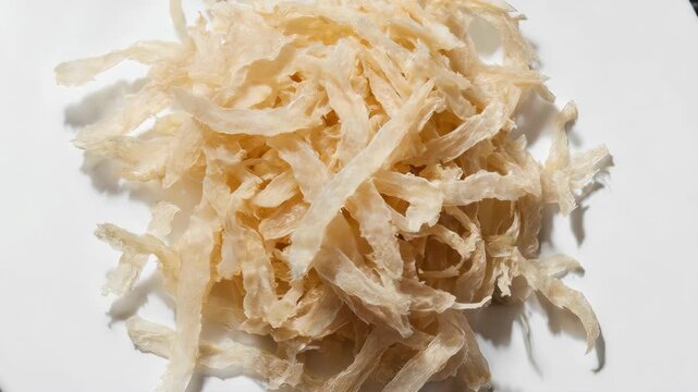 Close-up of Dried Fish Maw, Gourmet Food, Culinary Texture, White Background.