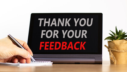 Thank you for your feedback symbol. Concept words Thank you for your feedback on black tablet. Beautiful white background. Businessman's hand. Business thank you for your feedback concept. Copy space.