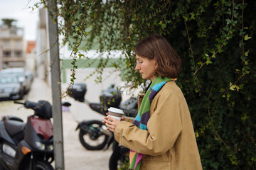 woman with coffee and phone by ivy, digital nomad break