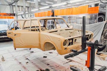 Professional anti corrosion undercoating treatment applied to hidden cavities of a car body. Long lasting metal protection and technical maintenance for extended vehicle lifespan.